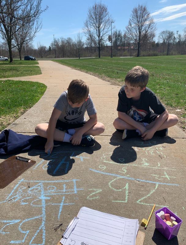 students doing math in chalk outside